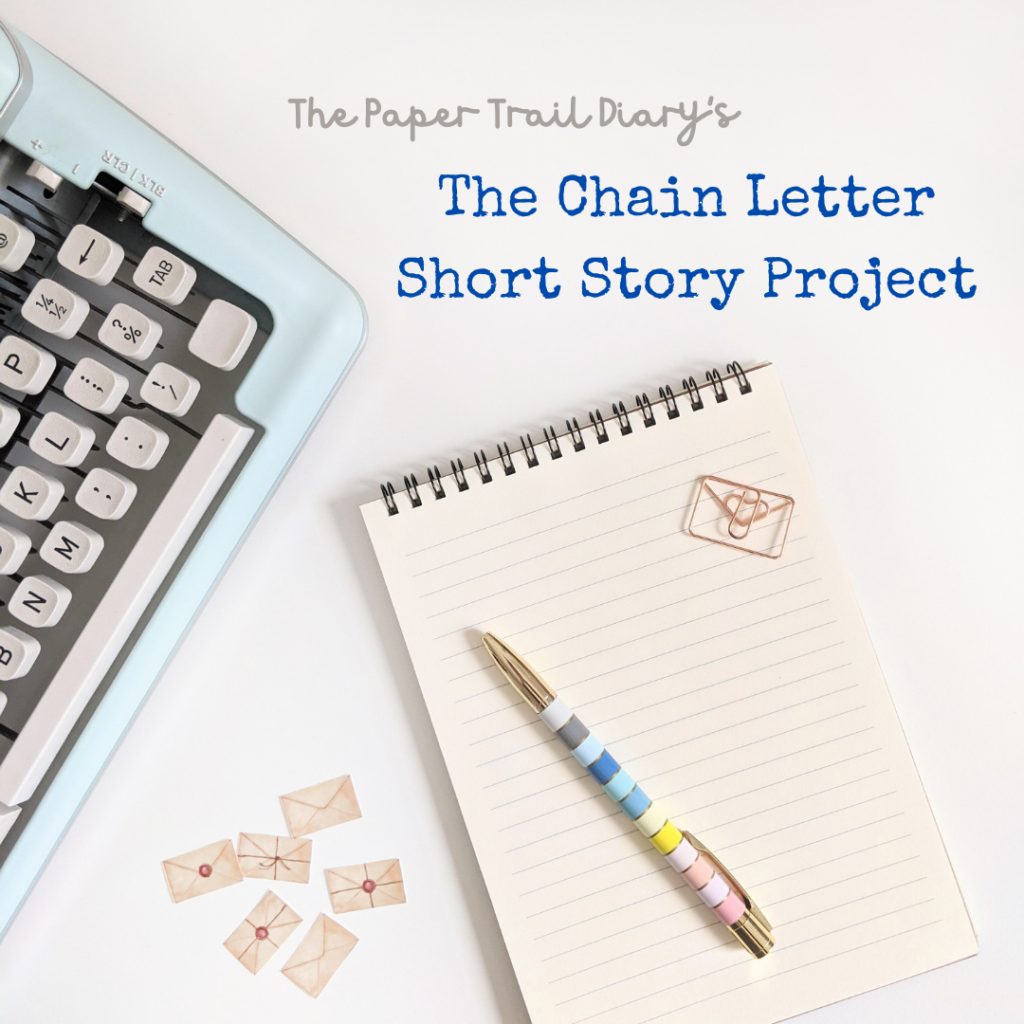 A typewriter next to some mini envelopes and a notebook with a pen and paperclip on top with the heading "The Paper Trail Diary's The Chain Letter Short Story Project."