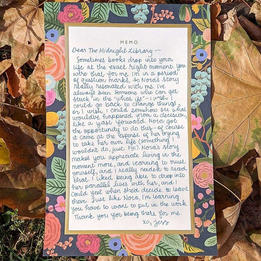 The letter to the book on a sheet of stationery lying on brown leaves.